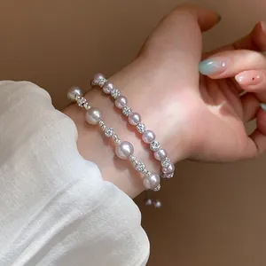 Detail of French style double-layer bracelet with irregular pearls and zircon beads