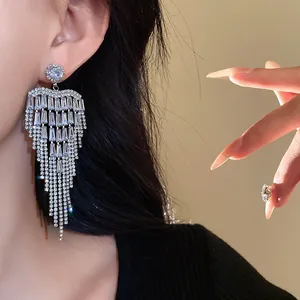 Elegant cascading silver needle zircon fringe earrings on a model for banquet wear
