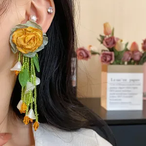 Sweet forest style flower tassel earrings featuring yellow fabric rose and green beads