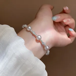 Close-up of a French style pearl bracelet with zircon beads on a woman's wrist