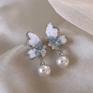 Exquisite butterfly drop earrings with shimmering crystals and elegant white pearls
