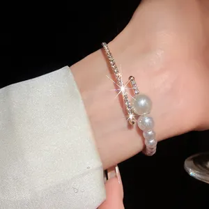 Close-up of elegant baroque open bracelet with pearls and sparkling rhinestones
