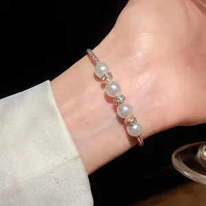 Close-up of elegant Baroque pearl bracelet with sparkling crystal rings on a wrist