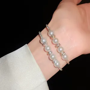 Elegant baroque pearl bracelets with crystal rhinestones shown on a model's wrist