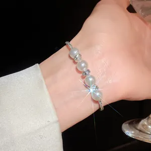 Detailed close-up of an elegant baroque rhinestone pearl bracelet on a wrist with a sparkle