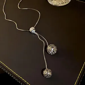 Long adjustable stainless steel necklace with rhinestone spherical pendants