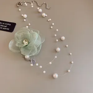 Detailed view of fairy-style mesh flower necklace with zircon pendant and pearls