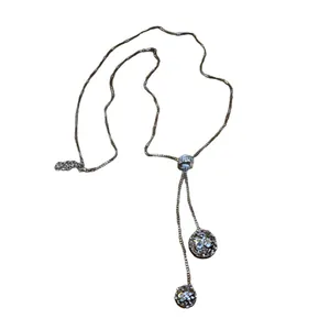 Elegant stainless steel long necklace with adjustable rhinestone slide and globes.