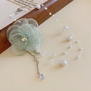 Detailed macro shot of a delicate mesh flower necklace featuring floating pearls and zircon drop