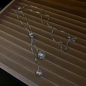 Detailed view of adjustable stainless steel long necklace featuring crystal hollow spheres