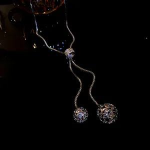 Close-up of adjustable stainless steel necklace with rhinestone slider and hollow balls