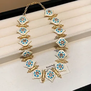 Close-up detail of vintage heart patterned enamel necklace with rhinestones
