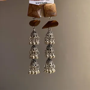 Vintage bohemian earrings featuring square wood pieces and silver-tone hollow tassel bells