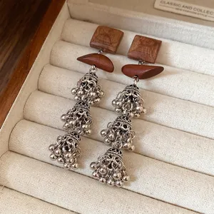 Retro bohemian wood square earrings with silver tassel details in jewelry box