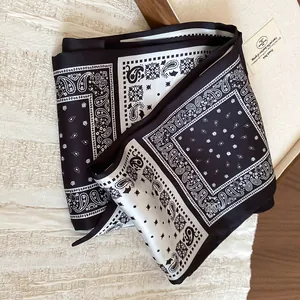 Detail of a paisley print silk scarf necklace in elegant black and white