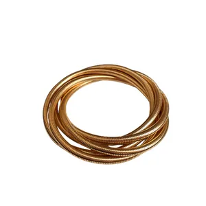 Minimalist gold-tone multi-layer spring bracelet with metallic finish for women