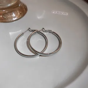 Minimalist silver hoop earrings with a high-polish finish, elegant jewelry for women