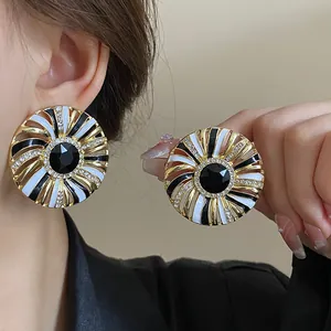 Vintage French court style gold earrings with black white enamel and shiny crystals