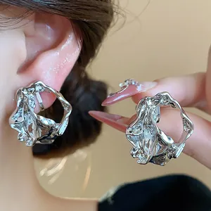 Detailed view of silver crinkled geometric ear clips with high-shine metallic texture.