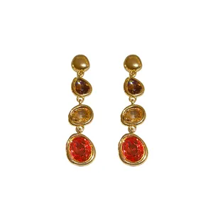 Elegant gold dangle earrings with gradient amber, yellow and orange oval faceted stones