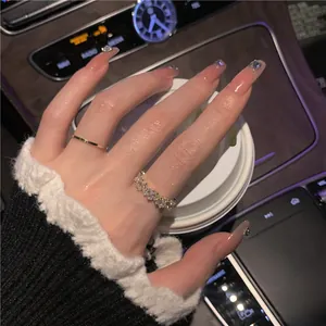 Detailed view of a gold-plated geometric zircon ring worn in a luxury car setting