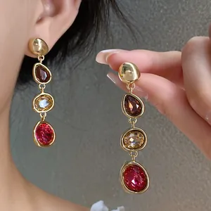 Close-up of French vintage drop earrings with colorful multi-stone crystal details