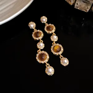 French vintage gold-tone drop earrings with pearls and amber tiger's eye stones.