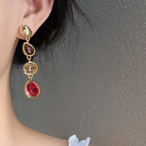 Close-up detail of elegant French court style drop earrings with multi-colored gemstones