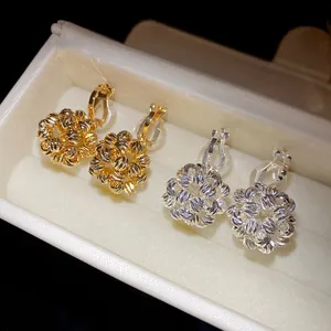 Detail showing 18k gold-plated and silver round cluster clip-on earrings in a gift box