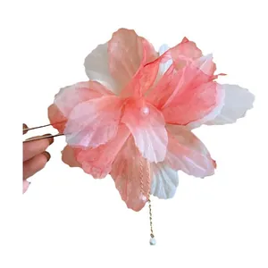 Elegant pink fabric flower hair pin with delicate gauze petals and pearl center detail