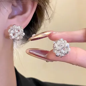 Detail view of silver floral cluster clip-on earrings with elegant 18k gold plating
