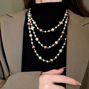 Elegant long multi-layered necklace with pearls and rhinestone flower charms