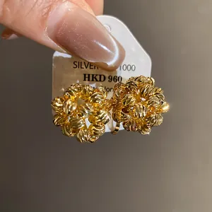 Detailed view of 18k gold plated round flower cluster earrings with textured surface