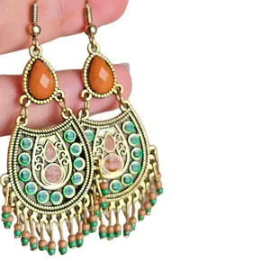Vintage Bohemian drop earrings featuring orange teardrop gems and colorful bead tassels