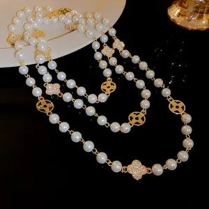 Detailed view of luxury long pearl necklace with sparkling diamond flower accents