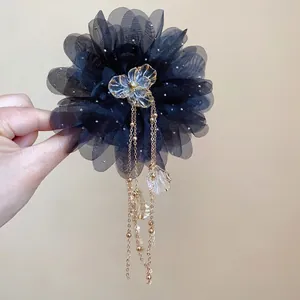 Elegant black chiffon flower hair claw clip with rhinestones and long gold chain tassels.