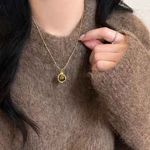 Elegant gold clavicle chain necklace featuring a natural tiger's eye stone pendant