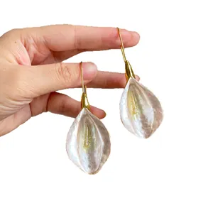 Minimalist white petal drop earrings with gold hooks for a stylish and elegant look