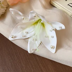 Gros plan détaillé d'une pince à cheveux en tissu blanc avec des perles élégantes