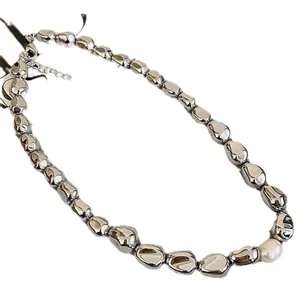 High-shine metallic beaded necklace with irregular silver nuggets and single white pearl accent