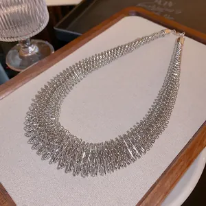 Macro detail shot of a silver spring-style choker necklace with a brilliant metallic texture