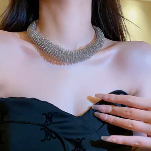 Detailed macro view of a silver spring-textured choker necklace on a model's neck