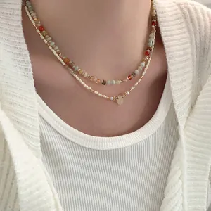 Detailed close-up of a double-layered beaded crystal necklace worn on a model's neck