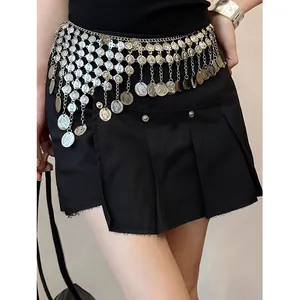 Stylish silver coin tassel waist chain accessory layered over black pleated mini skirt