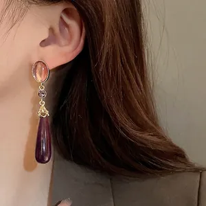Vintage Palace style water drop geometric earrings with silver needles on model