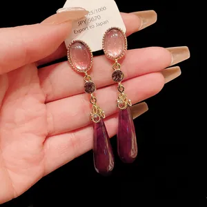Close-up of vintage purple teardrop earrings with S925 silver needles.