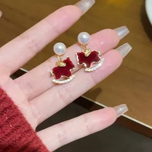 Elegant red rocking horse stud earrings featuring white pearls and sparkling crystal details
