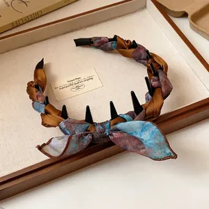 Elegant vintage silk scarf wrapped headband with a bow and hair teeth for high skull style