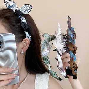 Close-up detail of elegant silk scarf wrapped bow headband set in vintage Korean style