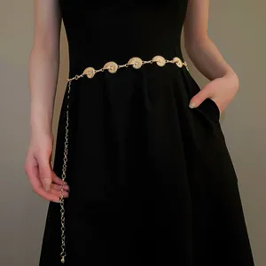 Exquisite golden nautilus shell charm metal waist chain accessory on black dress
